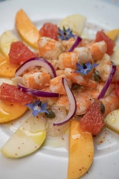 RECIPE CEVICHE OF SHRIMPS AND SCALLOPS WITH CITRUS FRUIT, LEMON, LIME, SQUEEZED ORANGE, GRAPEFRUIT AND FRUIT, PERSIMMON, APPLE, SEASONED WITH ESPELETTE PEPPER. High quality photo