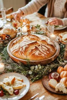 Beautiful round loaf of bread sits on a wooden table, surrounded by festive decorations and other dishes, creating a warm and inviting christmas atmosphere