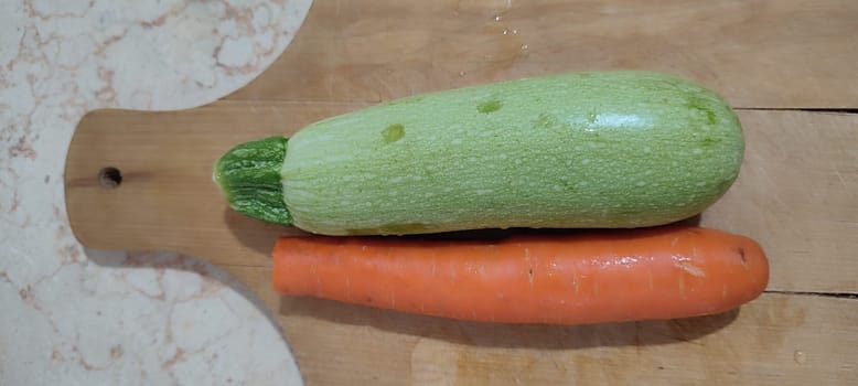 fresh zucchini and carrot, vegetables healthy food vegetarian cooking, wooden kitchen board High quality photo