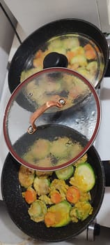 fresh zucchini and carrot, vegetables healthy food vegetarian cooking, frying pan stove kitchen . High quality photo