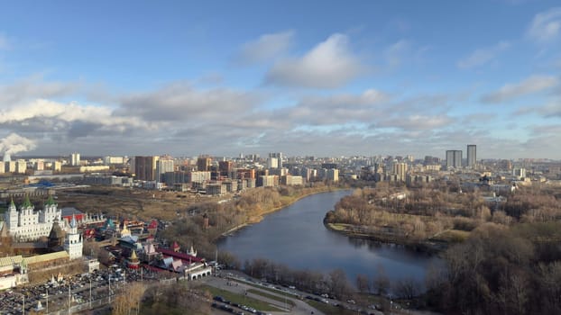 Panorama of Moscow from above overlooking buildings and pond on cold winter day, beautiful view of the capital of Russia in cold season with trees without foliage