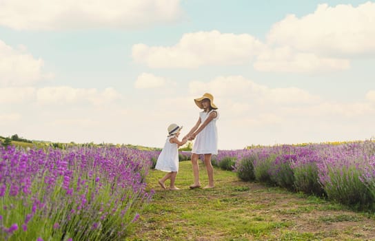 Child girl in lavender field. Selective focus. Kid.