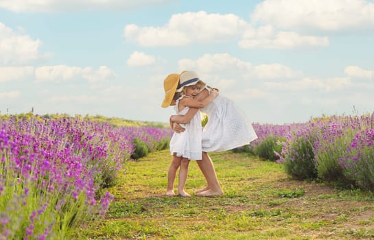 Child girl in lavender field. Selective focus. Kid.