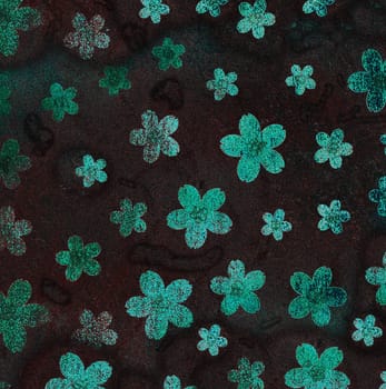 A lot of medium-sized green flowers are highlighted on a dark background