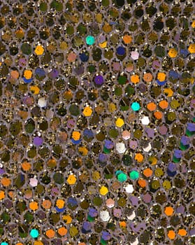 Colorful sparkling coating for decoration lots of small hexagonal shiny plates on the surface