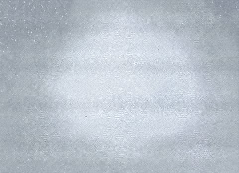Abstract gray background with a light flare in the center of the frame and microcracks on the surface with white and black dots