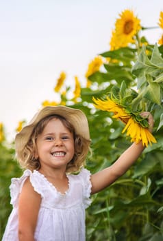 Child in a field of sunflowers. Selective focus. kid.