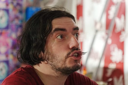 A surprised man's expression captures the moment in a vibrant cultural setting during a lively local festival