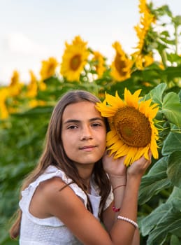 Child in a field of sunflowers. Selective focus. kid.