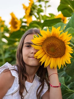 Child in a field of sunflowers. Selective focus. kid.