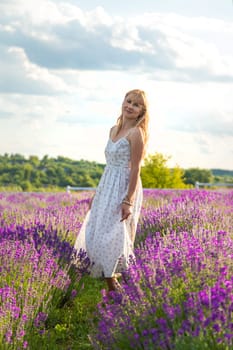 Woman in a lavender field. Selective focus. Nature.