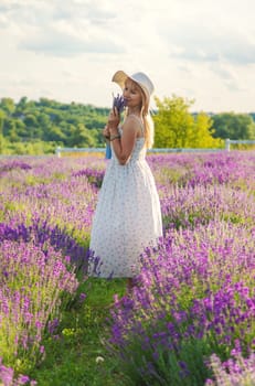 Woman in a lavender field. Selective focus. Nature.