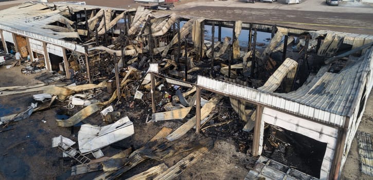 A building is on fire and has been destroyed. The fire has caused a lot of damage to the building and the surrounding area