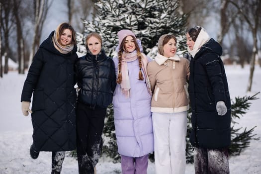 Five joyful schoolgirls, wrapped up in cozy winter coats, delight in a snowy day by a pine tree, celebrating their friendship and the beauty of the winter season