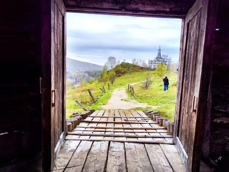 The historic wooden church stands as a filming backdrop in the Perm Region, capturing a peaceful landscape during movie production.