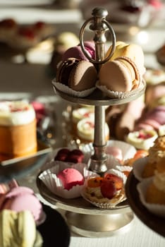 A table with a variety of desserts and pastries. The desserts are arranged in glass bowls and trays.
