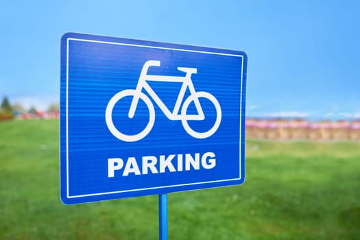 A sky blue traffic sign with a bicycle wheel design on it. The font is bold and eyecatching, drawing attention to the presence of bicycle lanes in the area