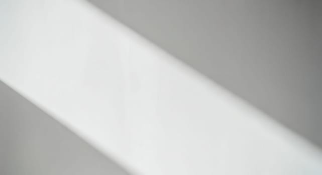 Abstract shadows create dynamic patterns on a white textured surface, emphasizing minimalist design. the interplay of light and shadow brings depth and interest, suitable for backgrounds, modern art, or design inspiration.