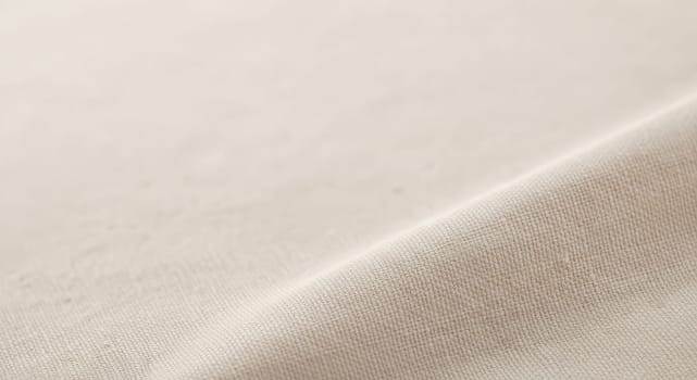 Close-up of a neutral beige fabric showcasing its detailed texture and fine weave. ideal for use as a background in design projects, textile patterns, or organic material studies, emphasizing simplicity and versatility.