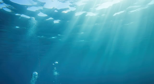 Tranquil underwater scene featuring calm blue waters with gentle sunlight penetrating the surface. air bubbles rise toward the light, creating a peaceful ambiance, perfect for themes related to nature, tranquility, and marine life.