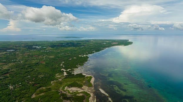 Tropical island against the blue sky and clouds. Bantayan island, Philippines.