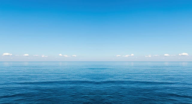 A serene ocean scene under a vast blue sky meeting at a distant horizon, conveying tranquility and calm. perfect for themes of relaxation, meditation, serenity, and nature's beauty.