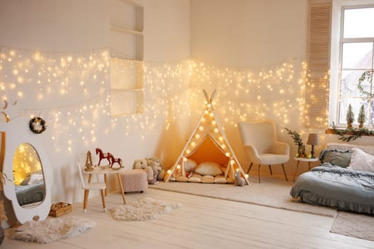 Cozy children's bedroom interior with tent, gifts and decorated Christmas tree