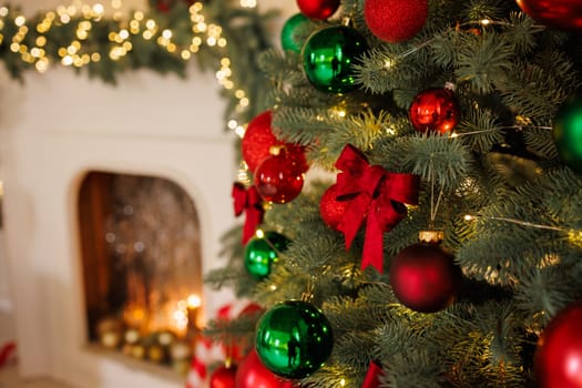 Christmas red bow on a tree, close-up, against the background of a fireplace, stylish New Year's decor