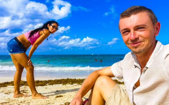 Couple man and woman together at the Caribbean beach and sea in Playa del Carmen Quintana Roo Mexico.