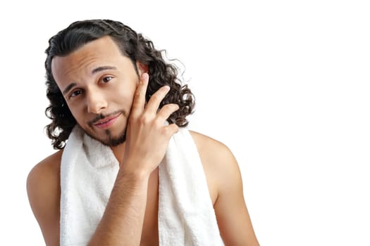 Smiling man with curly hair showing confidence while holding a towel in studio