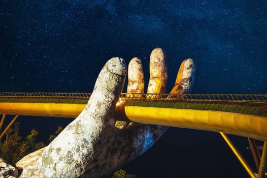 Golden Bridge in Ba Na Hills park in Da Nang in Vietnam on the mountain at night