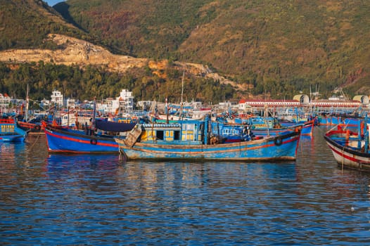 Traditional Vietnamese fishing boats and ships in the bay on the river at the Vinh Truong fishing port in Nha Trang. Nha Trang, Vietnam - September 8, 2024