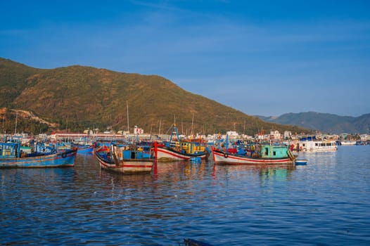 Traditional Vietnamese fishing boats and ships in the bay on the river at the Vinh Truong fishing port in Nha Trang. Nha Trang, Vietnam - September 8, 2024