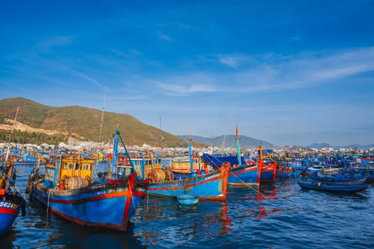 There are many traditional Vietnamese fishing boats and ships in the bay on the river at the Vinh Truong fishing port in Nha Trang. Nha Trang, Vietnam - September 8, 2024