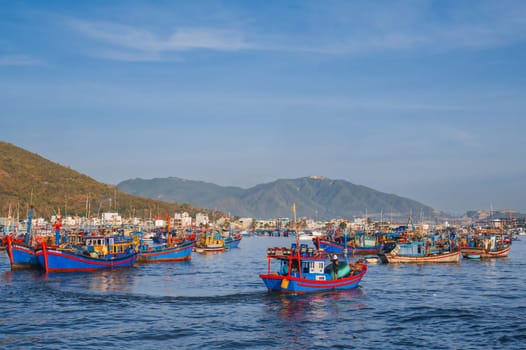 Traditional Vietnamese fishing boats, ships and vessels at the fishing seaport on the sea in Nha Trang. Nha Trang, Vietnam - September 8, 2024
