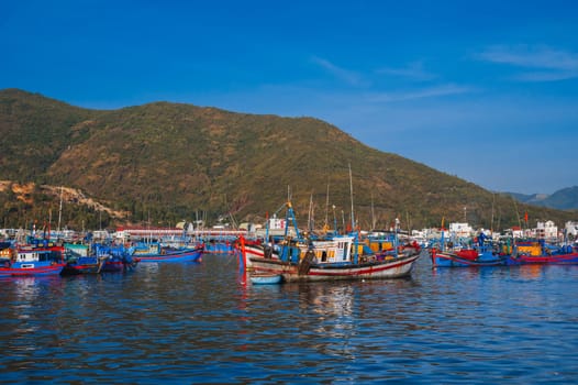 Traditional Vietnamese fishing boats and ships in the harbor at sea at the fishing port in Nha Trang in Asia. Nha Trang, Vietnam - September 8, 2024