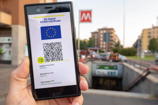 Woman showing on smartphone EU Digital Covid Certificate Green Pass with quad code. Underground background.