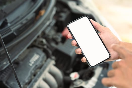 Man using mobile apps or online assistance for automotive diagnostics or emergency services.