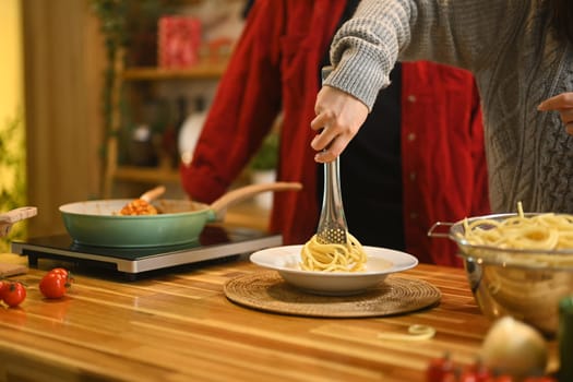 Young couple preparing ingredients for a festive Christmas dinner in their home kitchen.