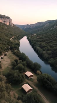 A stunning river valley at sunset, with lush green hills and a tranquil river reflecting the evening light.