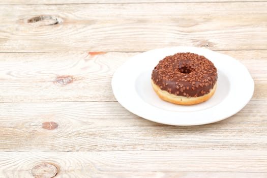 Enjoy a tempting chocolate donut with colorful sprinkles, perfect for dessert lovers and food photography