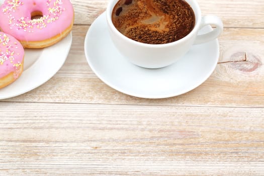Indulge in delicious and sweet donuts partnered with delightful and aromatic coffee, ideal for a cozy snack break