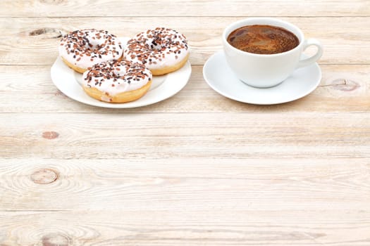 Indulge in freshly baked, warm donuts paired with aromatic coffee served beautifully on a rustic wooden table
