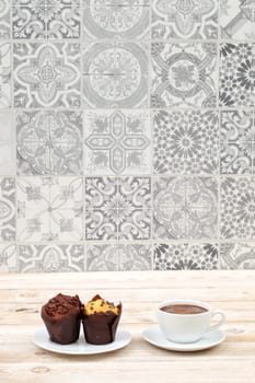 Indulge in decadent chocolate and vanilla muffins, perfectly paired with a warm cup of freshly brewed coffee