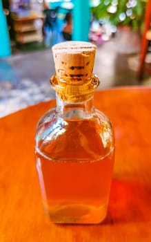 olive oil bottle dispenser on wooden table in Zicatela Puerto Escondido Oaxaca Mexico.