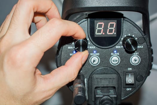 hand adjusts the flash light candlestick behind