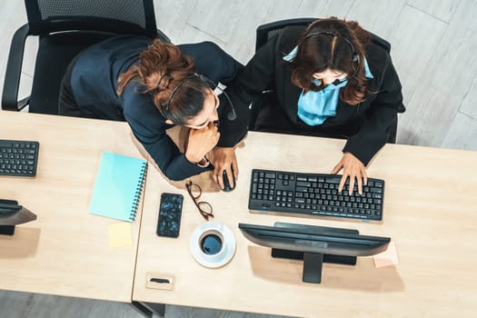 Business people wearing headset shot from top view in office working with computer. Jivy