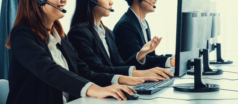 Business people wearing headset working in office to support remote customer or colleague. Call center, telemarketing, customer support agent provide service on telephone video conference oratory call