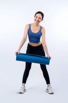 Young attractive asian woman portrait in sportswear with exercising mat. Healthy exercise and workout routine lifestyle concept. Studio shot isolated background. Vigorous