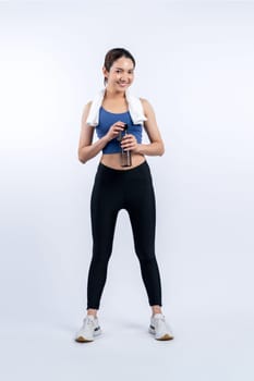 Athletic and sporty asian woman resting and drink water after intensive cardio workout training. Healthy exercising and fit body care lifestyle pursuit in studio shot isolated background. Vigorous